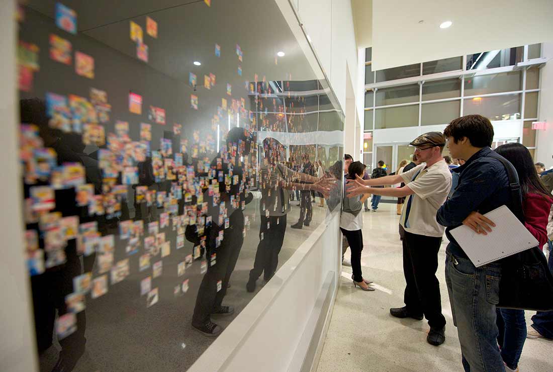 students looking at art piece at gallery QI