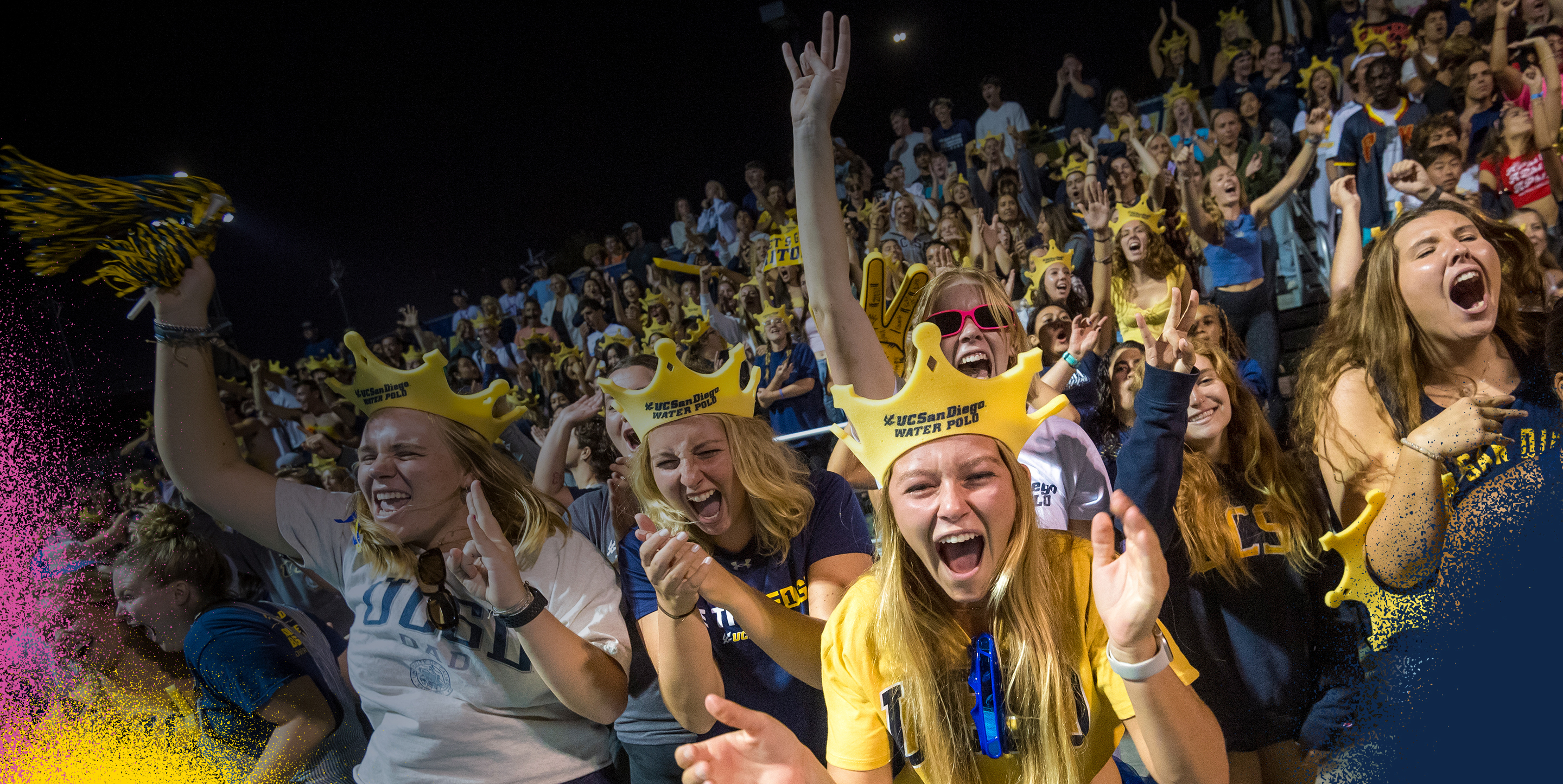 Students cheering in a crowd at a water polo game.