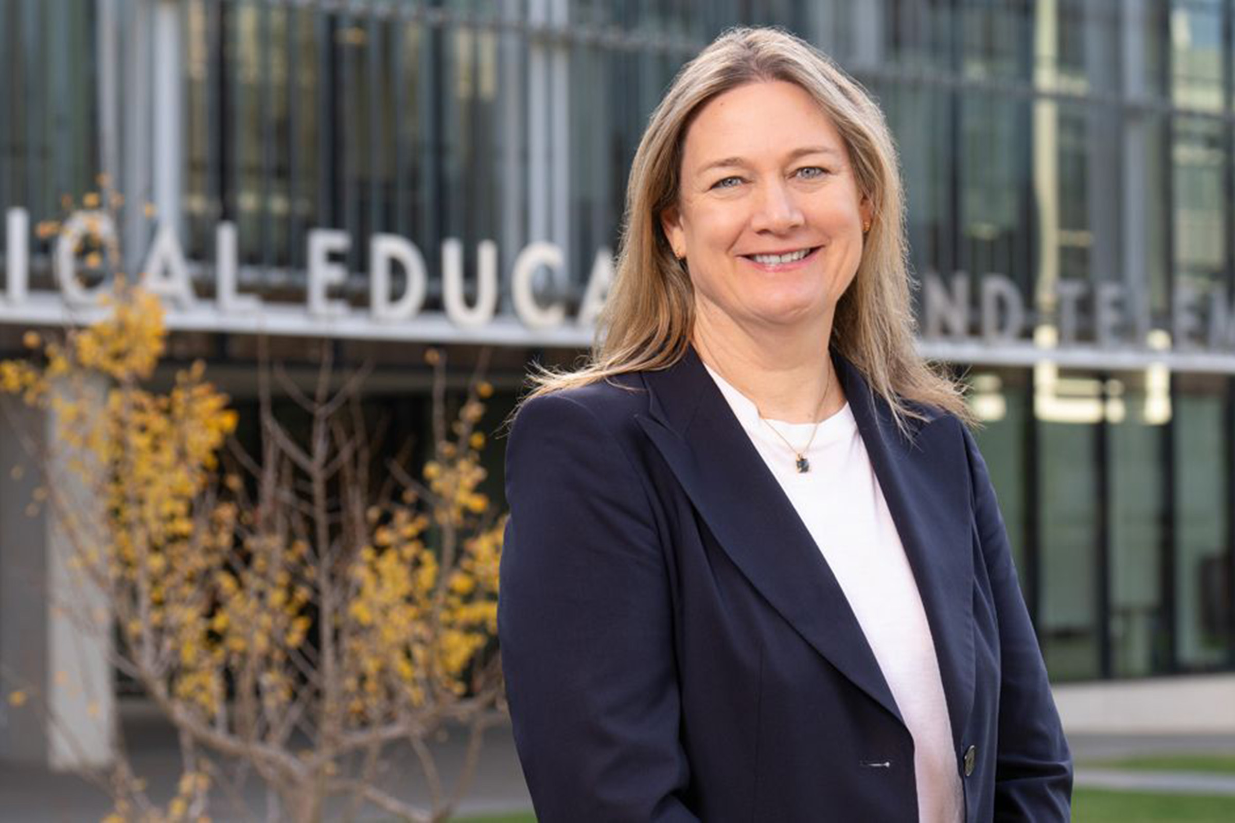 Dr. Barbara Jung is pictured in front of a School of Medicine building